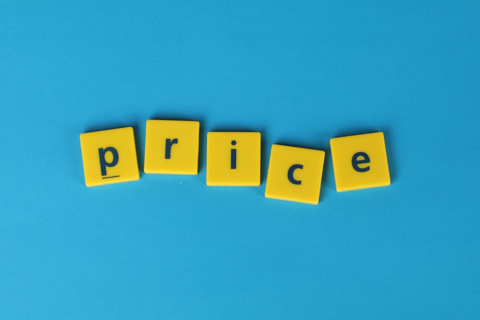 A close-up view of five yellow plastic letter tiles arranged on a light blue background, spelling the word 'price' in lowercase black letters. The tiles are slightly tilted and evenly spaced, with the